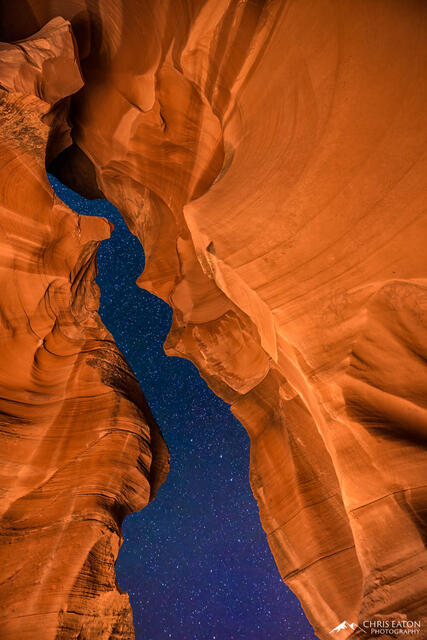 A crack in Antelope Canyon reveals a night sky full of stars.
