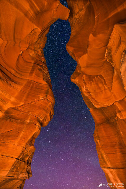 A night sky full of stars through the entrance of Antelope Canyon.