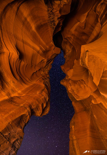 The night sky full of stars seen through the opening of Antelope Canyon.
