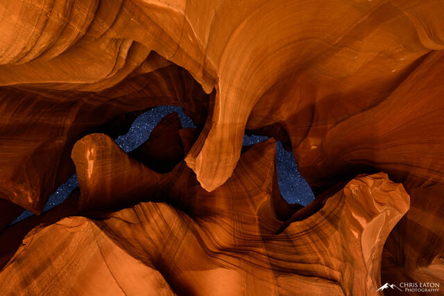 A narrow opening in Antelope Canyon reveals a night sky full of stars.