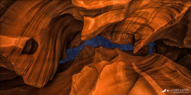 A night sky full of stars shine through the narrow opening of Antelope Canyon.