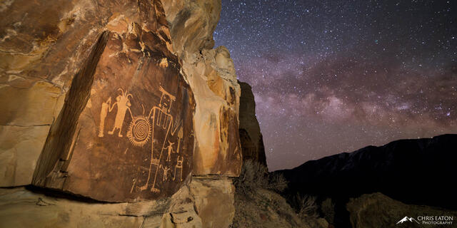 The Milky Way rises behind the McKee Spring Petroglyph Panel in Dinosaur National Monument.
