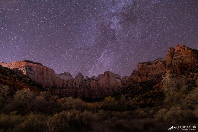 The outer rim of the Milky Way galaxy rises above the Temples and Towers of the Virgin in Zion National Park.