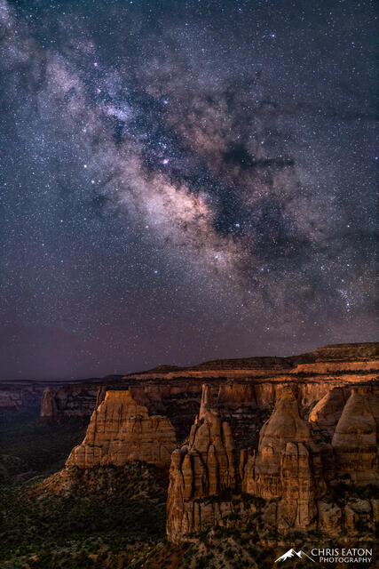 The Milky Way rises above the Wingate Sandstone Monuments that dominate Monument Canyon and its sandstone monoliths.