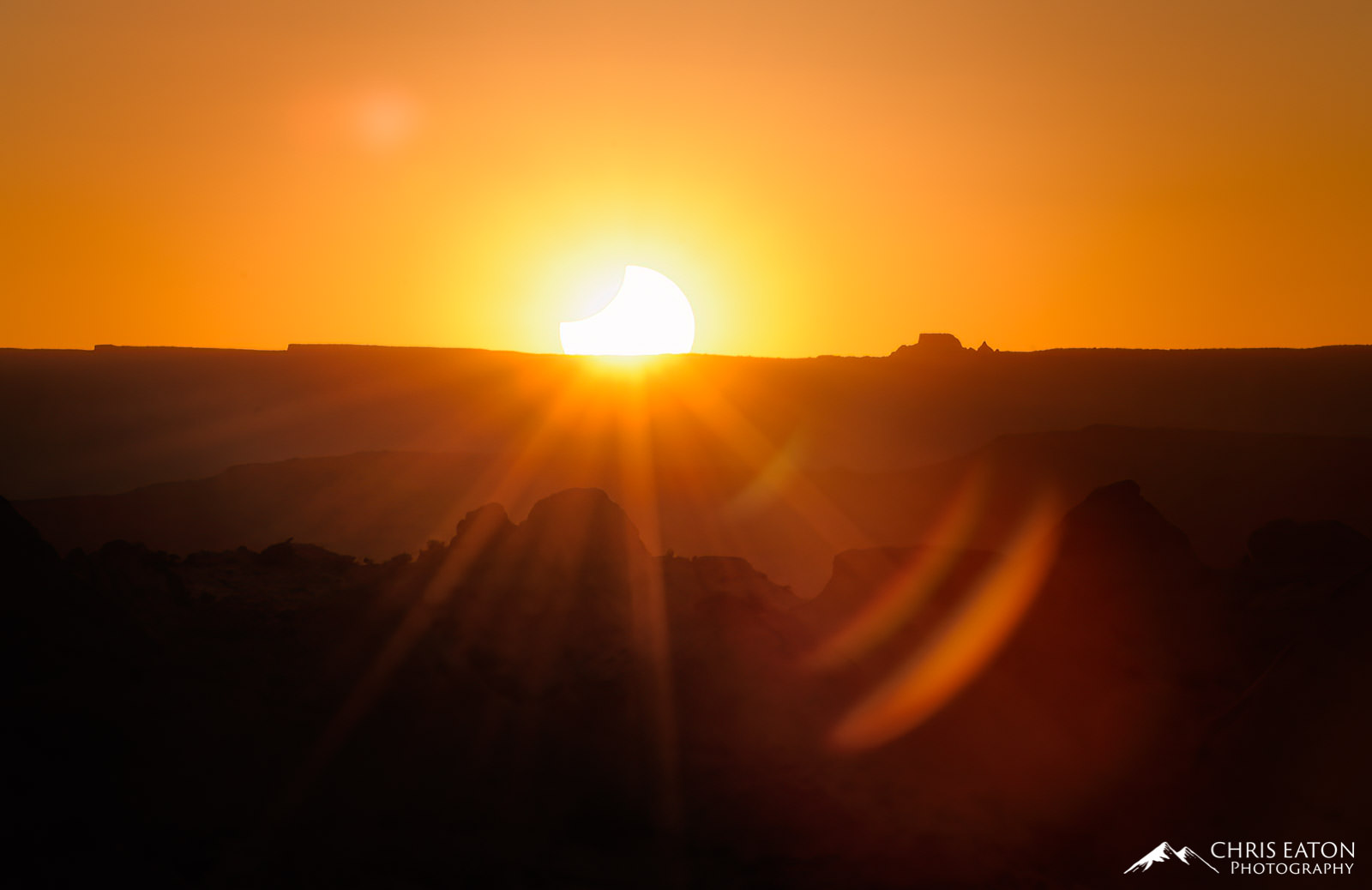 The setting sun in partial eclipse.