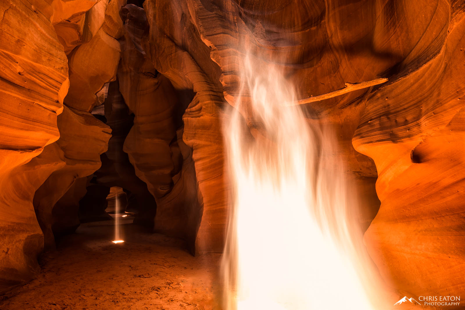 At high noon in the heart of summer, Upper Antelope Canyon is pierced with numerous light beams. Some of these shafts of sunlight...