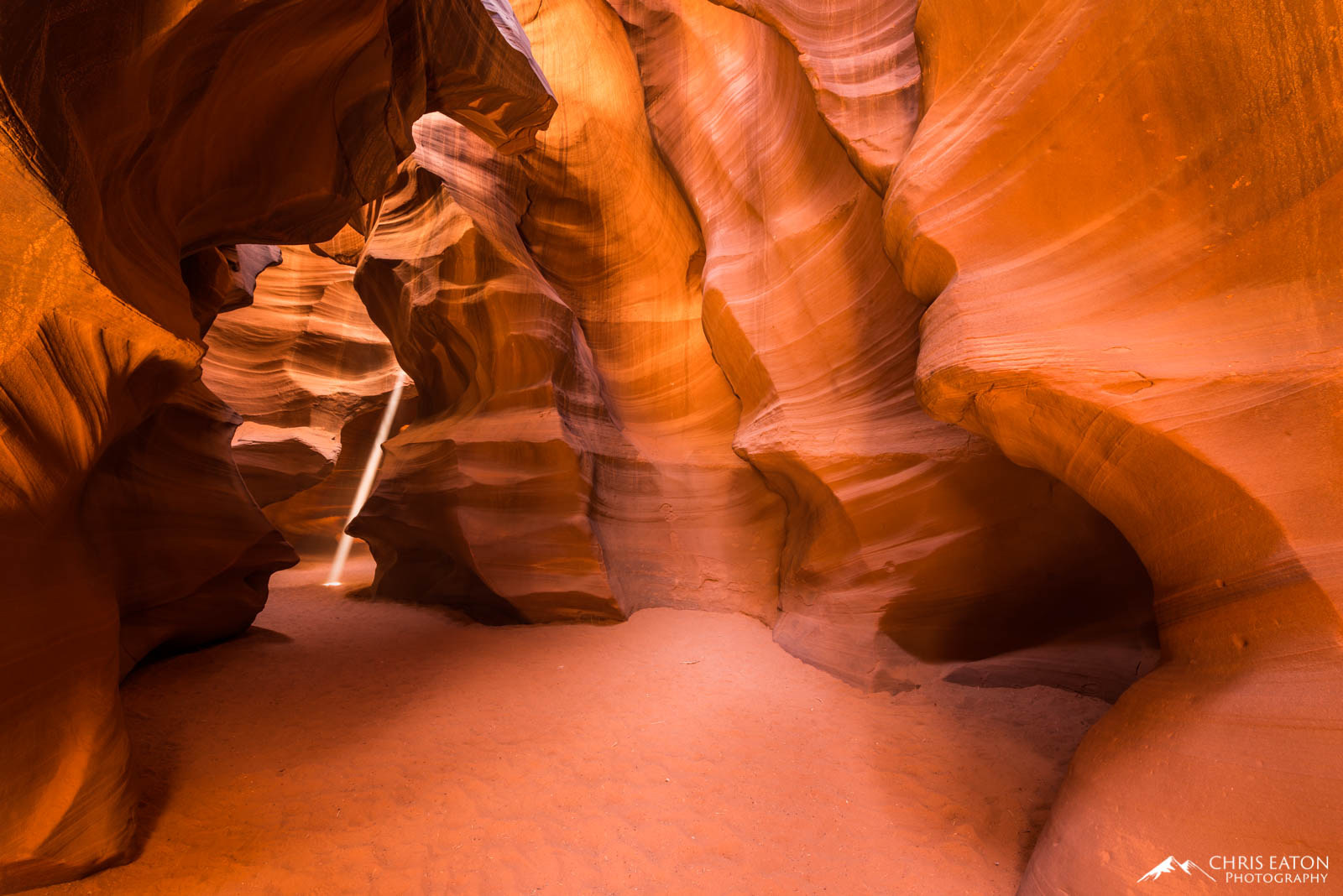A narrow shaft of sunlight penetrates into the area that separates the first and second chamber of Upper Antelope Canyon