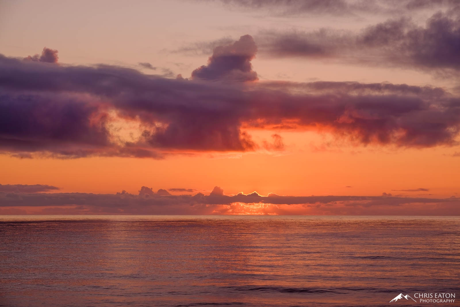 The sun sets on the Pacific Ocean at Heceta Head, painting the sky and the water in soft, yet fiery colors.