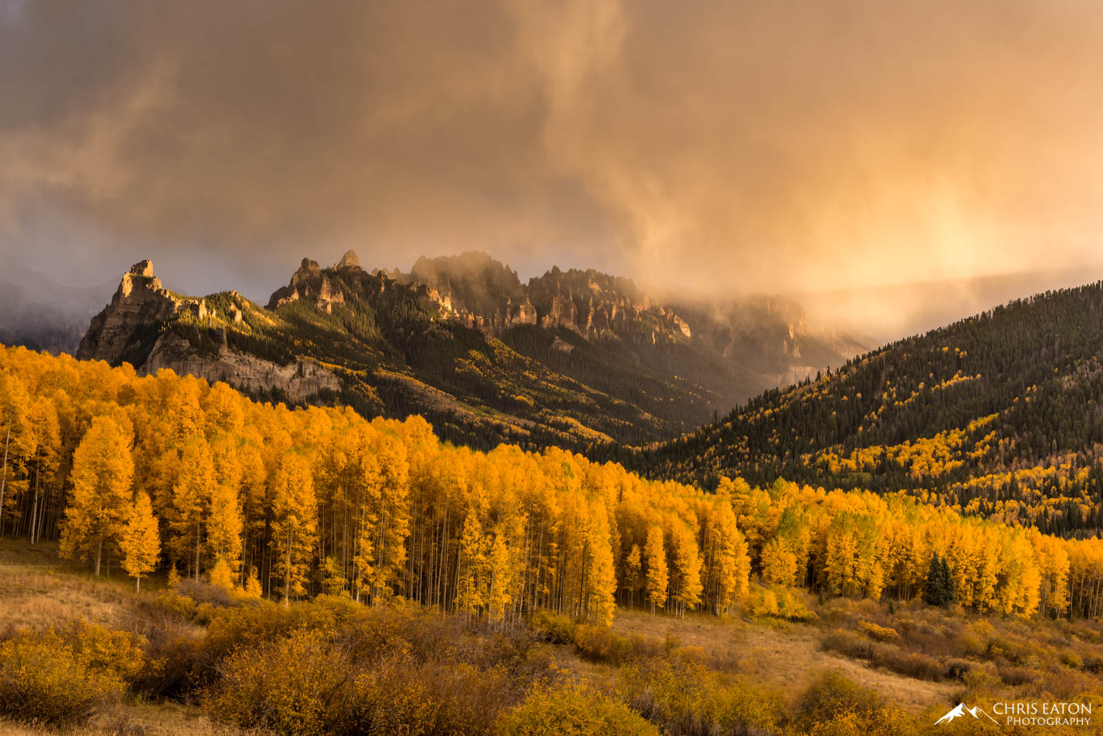 An unsettled sky is illuminated by sunset light over Turret Ridge in the Cimarron Range of the San Juan Mountains of Colorado...