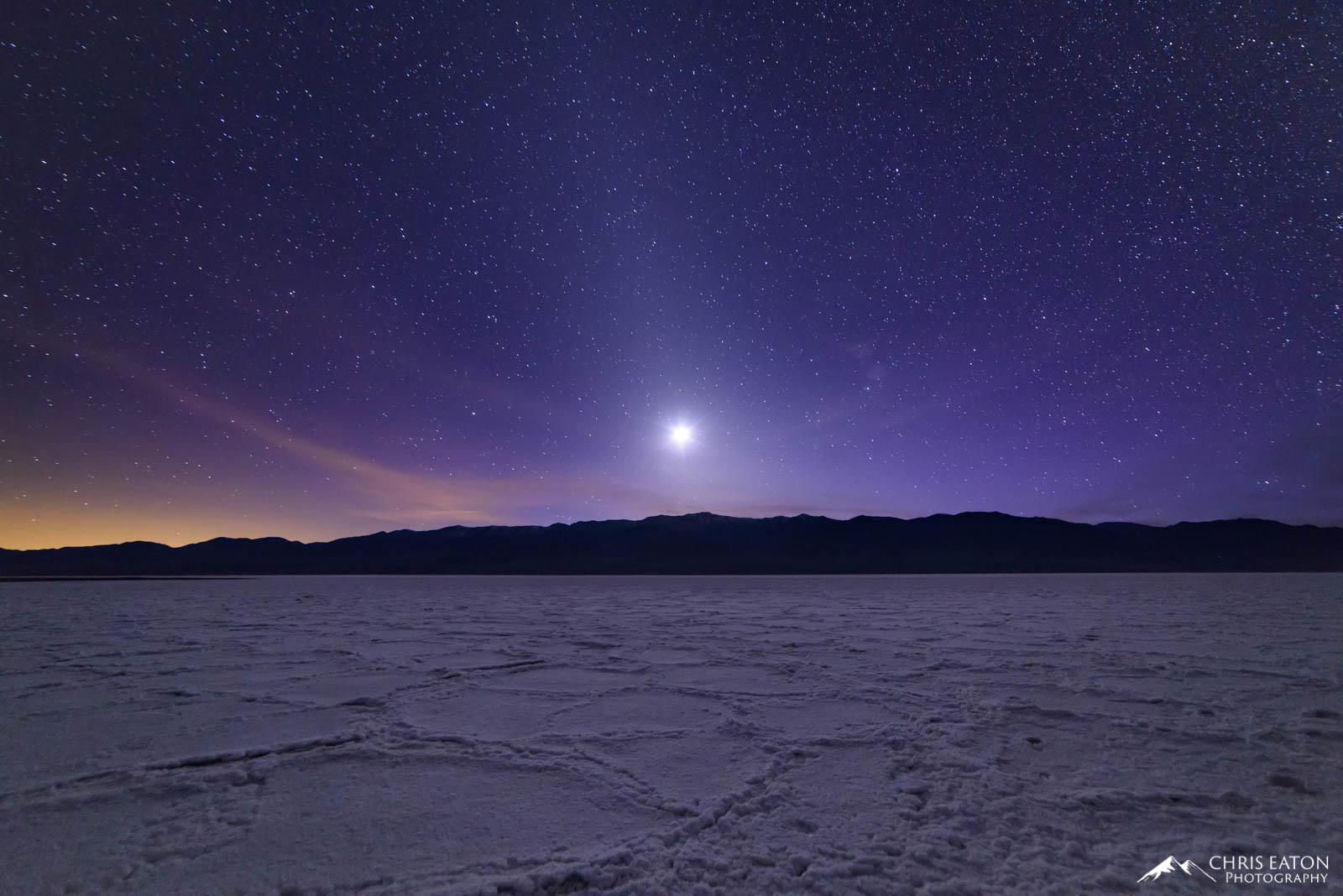 Setting moon over Badwater Basin in Death Valley National Park.
