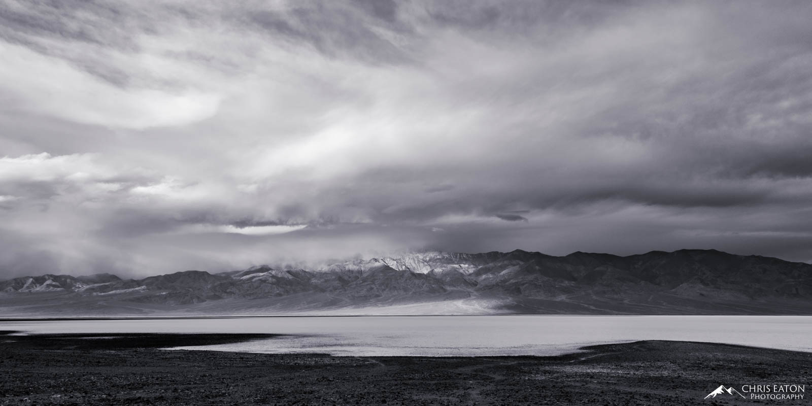 A later winter storm churns over Badwater Basin and the Panamint Range in Death Valley National Park. Telescope Peak is obscured...