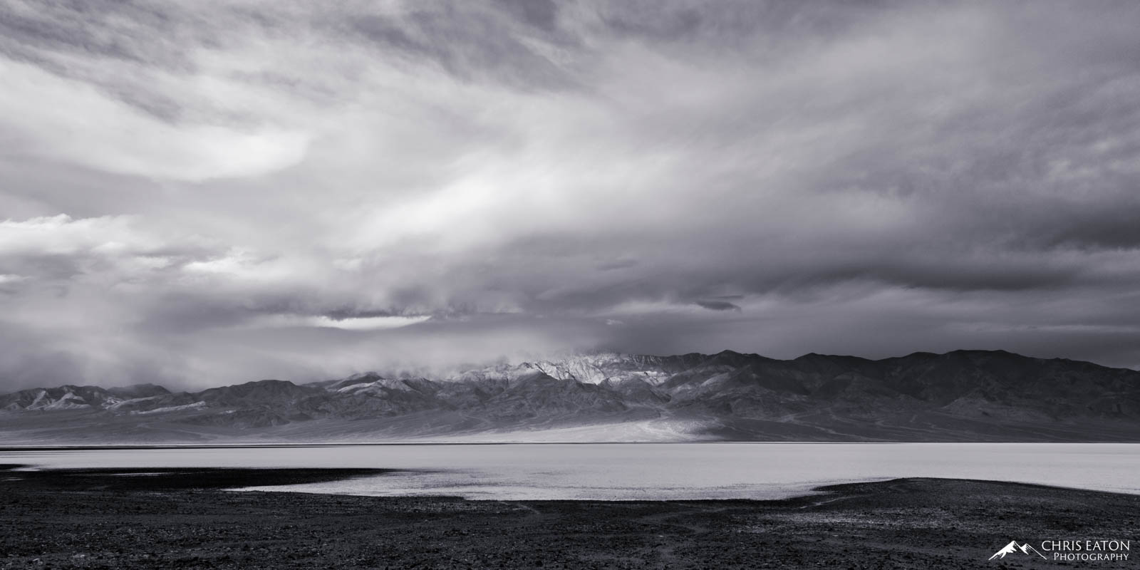 Badwater Storm I A later winter storm churns over Badwater Basin and the Panamint Range in Death Valley National Park. Telescope Peak is obscured...