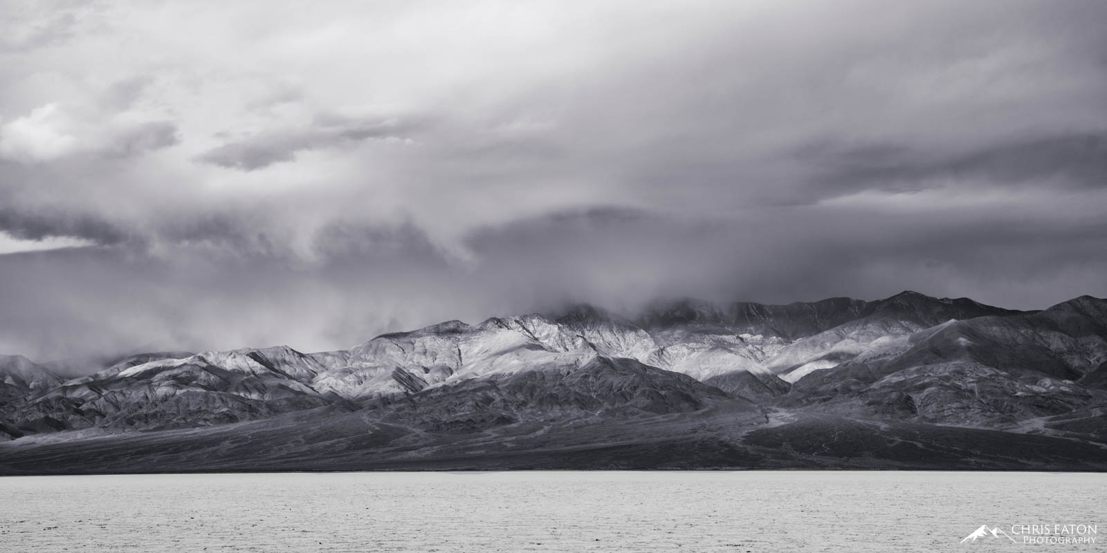 Badwater Storm II A later winter storm churns over Badwater Basin and the Panamint Range in Death Valley National Park. Telescope Peak is obscured...