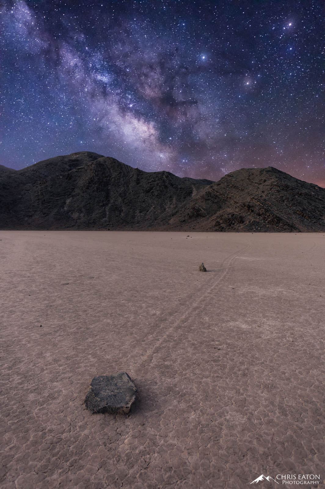 The Milky Way galaxy rises over a sailing stone at Racetrack Playa in Death Valley National Park.