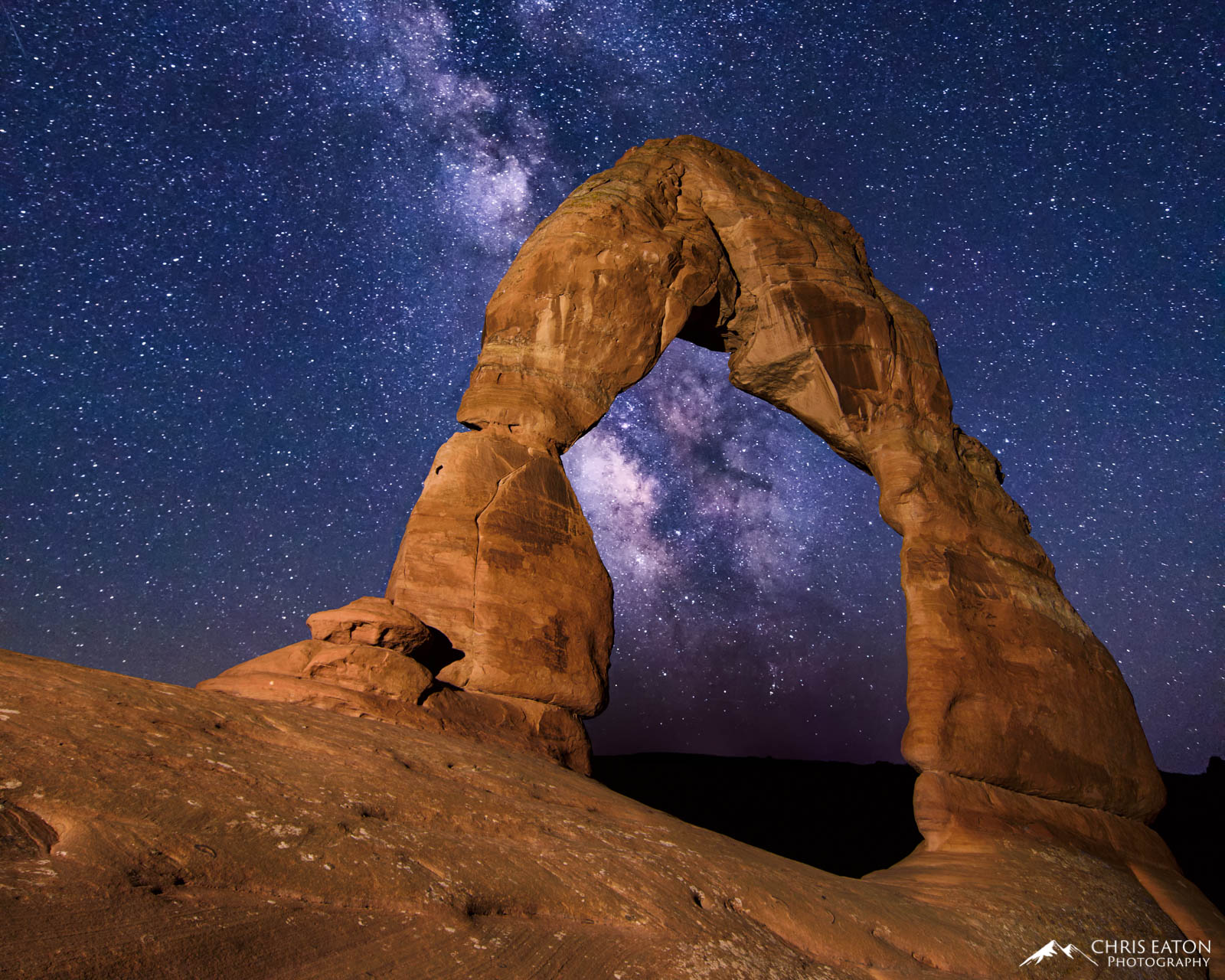 The center of our Milky Way galaxy shines brightly through Delicate Arch in Arches National Park.