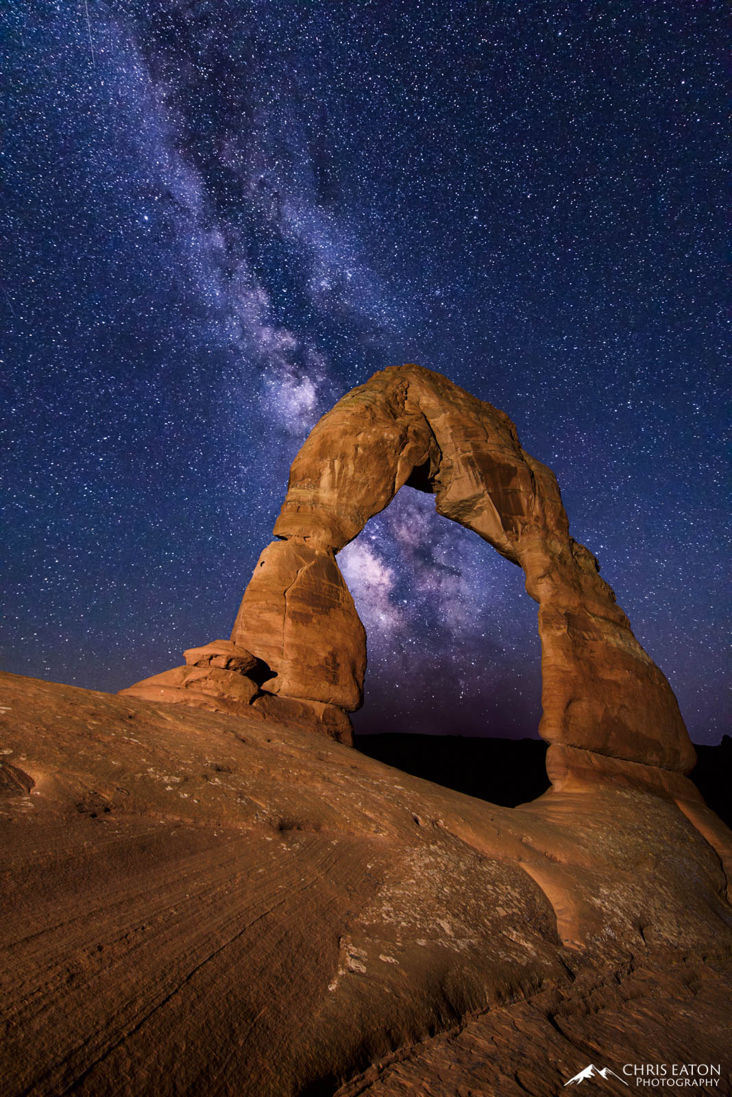 The center of our Milky Way galaxy shines brightly through Delicate Arch in Arches National Park.