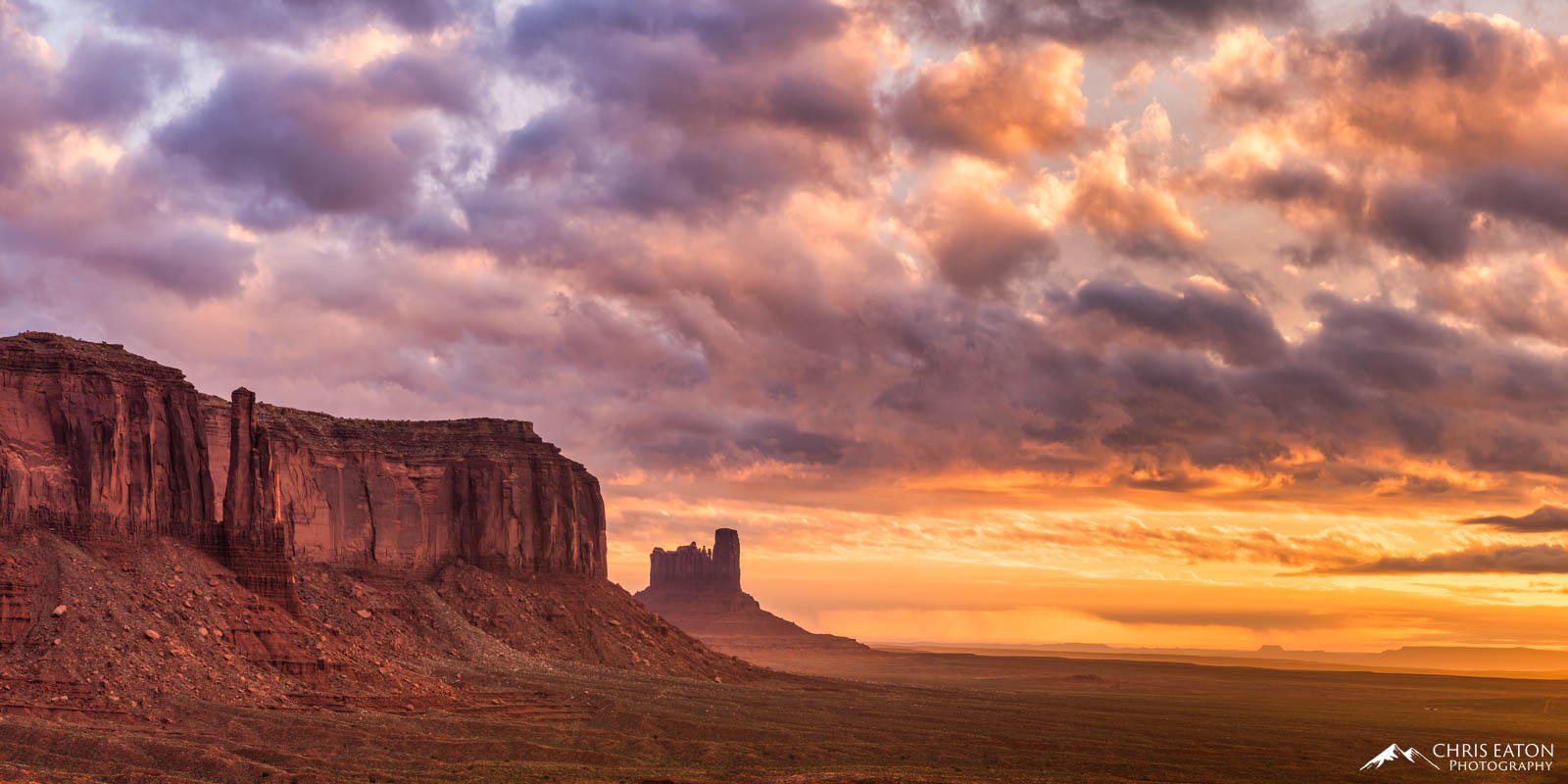 Sentinel Mesa and the Stagecoach formation are bathed in the fiery light of another spectacular sunrise at Monument Valley Navajo...