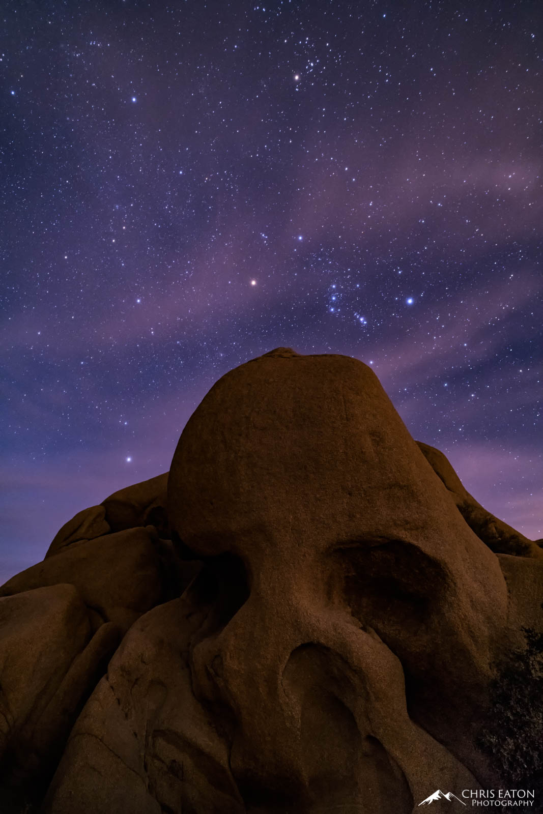 The constellation Orion rises above Skull Rock in the Jumbo Rocks area of Joshua Tree National Park.