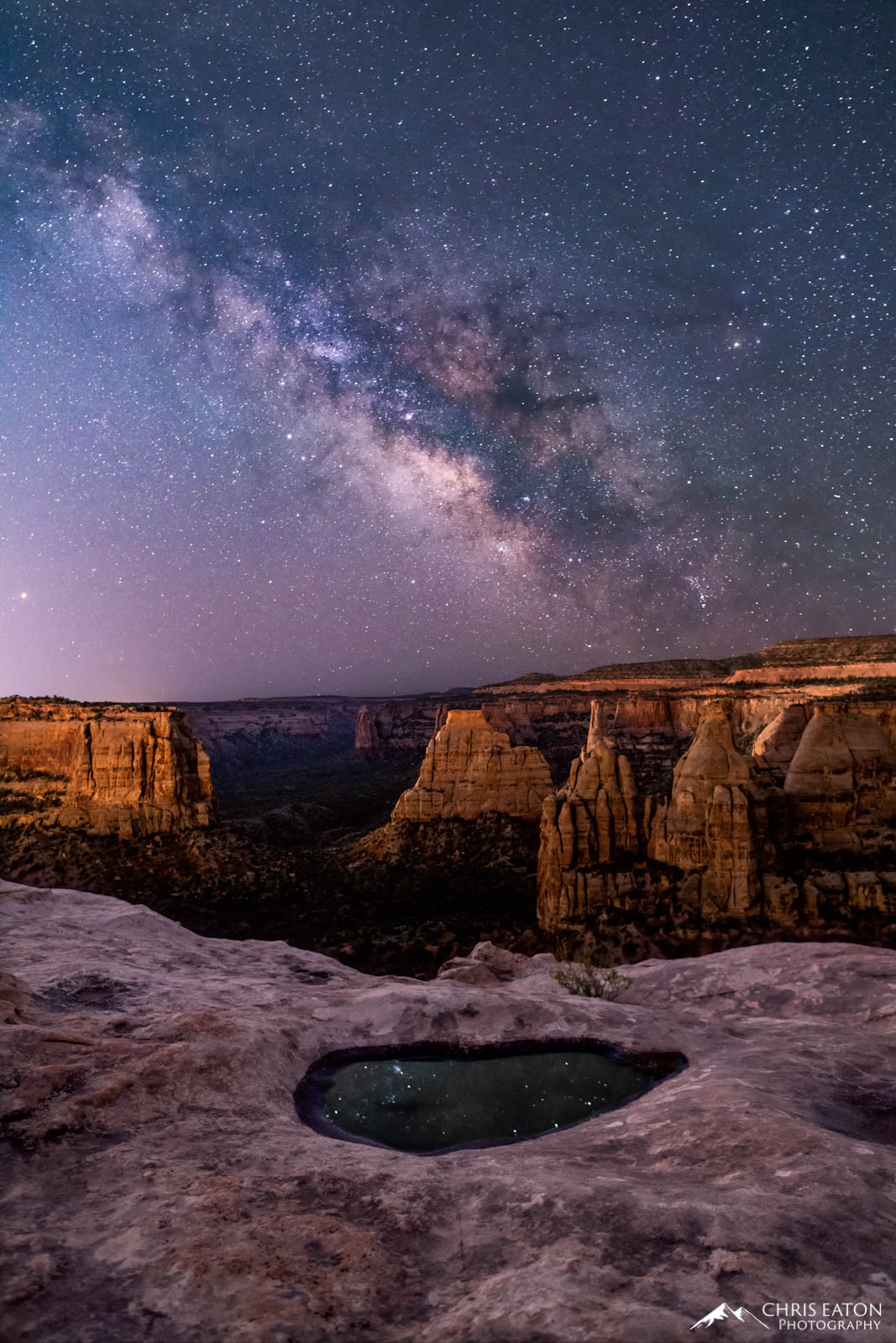 Milky Way Rising, Monument Canyon The rising Milky Way is reflected in a pothole of water along the cliff rim above Monument and Wedding Canyons.
