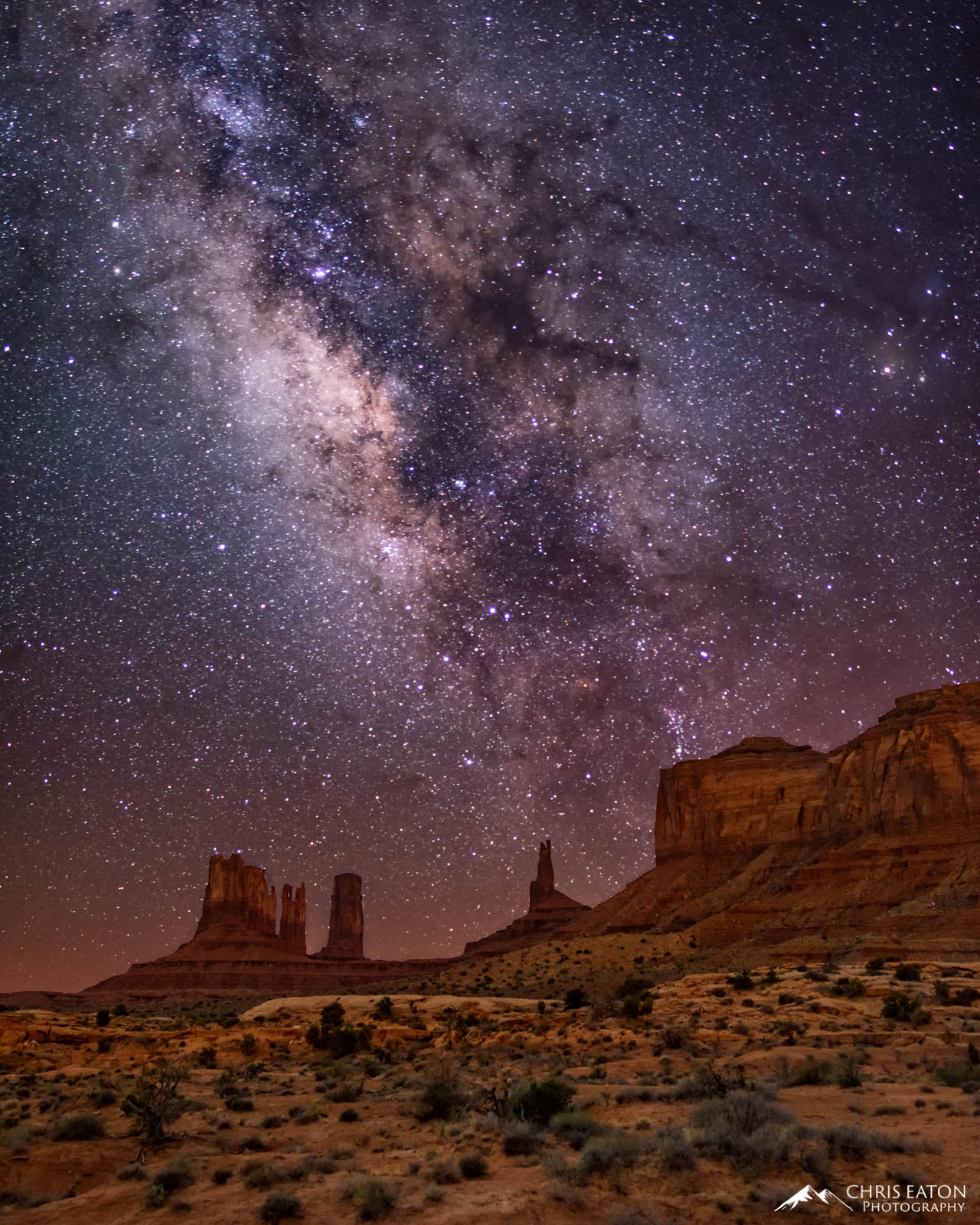 The center of the Milky Way Galaxy rises above The Stagecoach, Big Indian, and Brigham's Tomb formations in Monumernt Valley Navajo Tribal Park.
