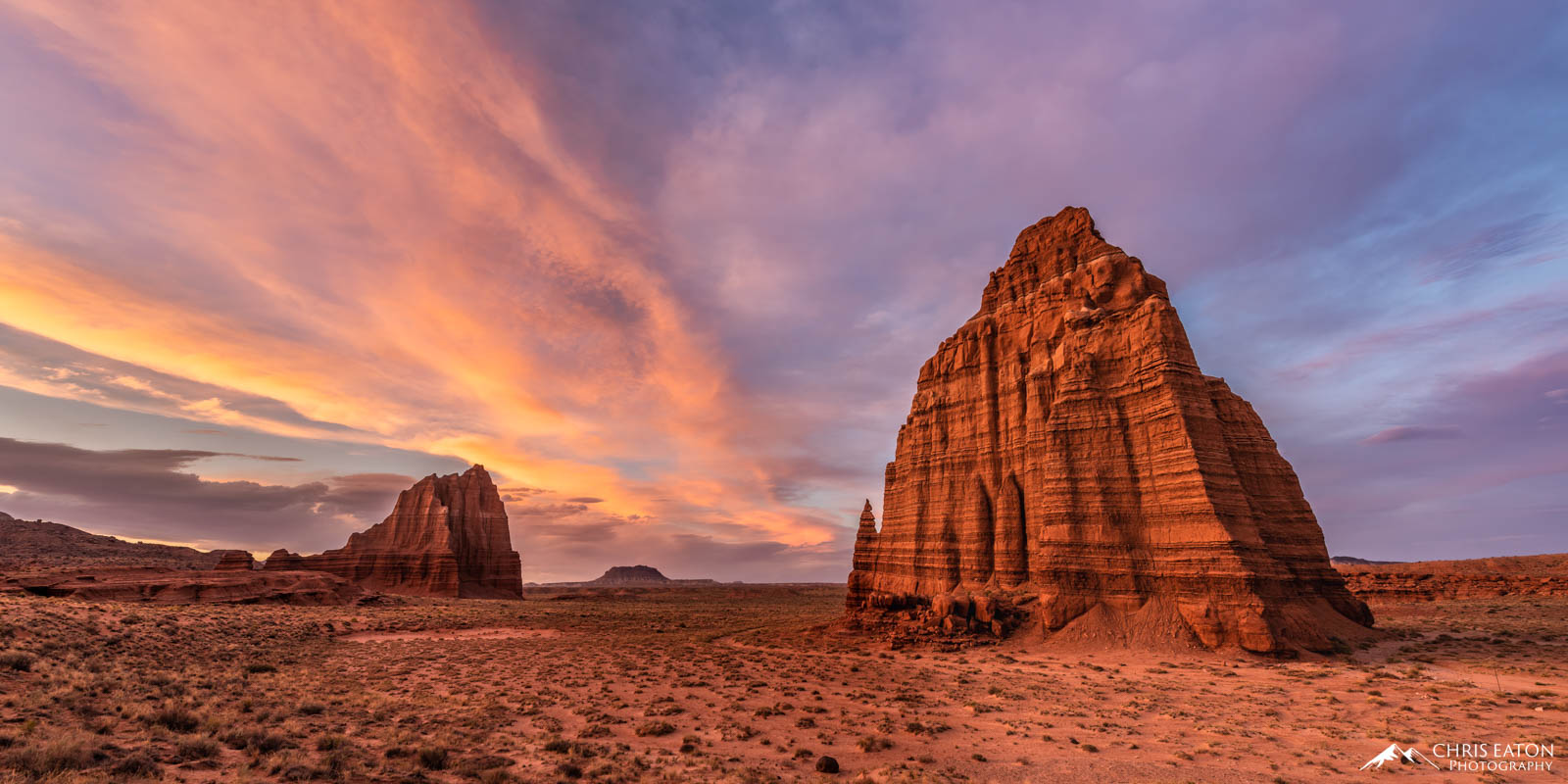 Teh last light of the setting sun paints the high clouds over The Temple of the Sun and the Temple of the Moon in Cathedral Valley...