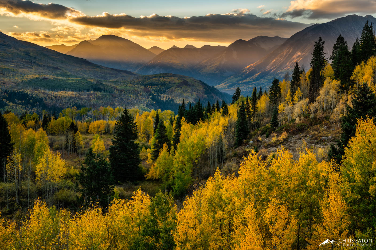 Sunrise Over the Crystal River Valley The first rays of sunlight filters through the mountain pass above the Crystal Ruver Valley. The mountainsides are painted with...