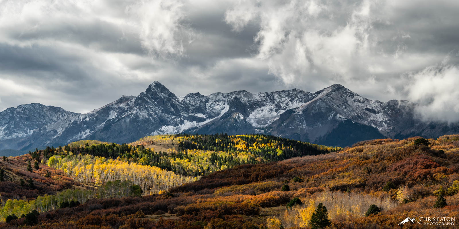 Stormy clouds over the Mt. Sneffels Range and fall color aspen trees in the San Juan Mountains of Colorado.