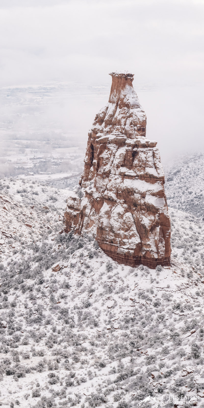 A breaking winter storm over Colorado National Monument reveals a winter wonderland around Independence Monument in Monument...