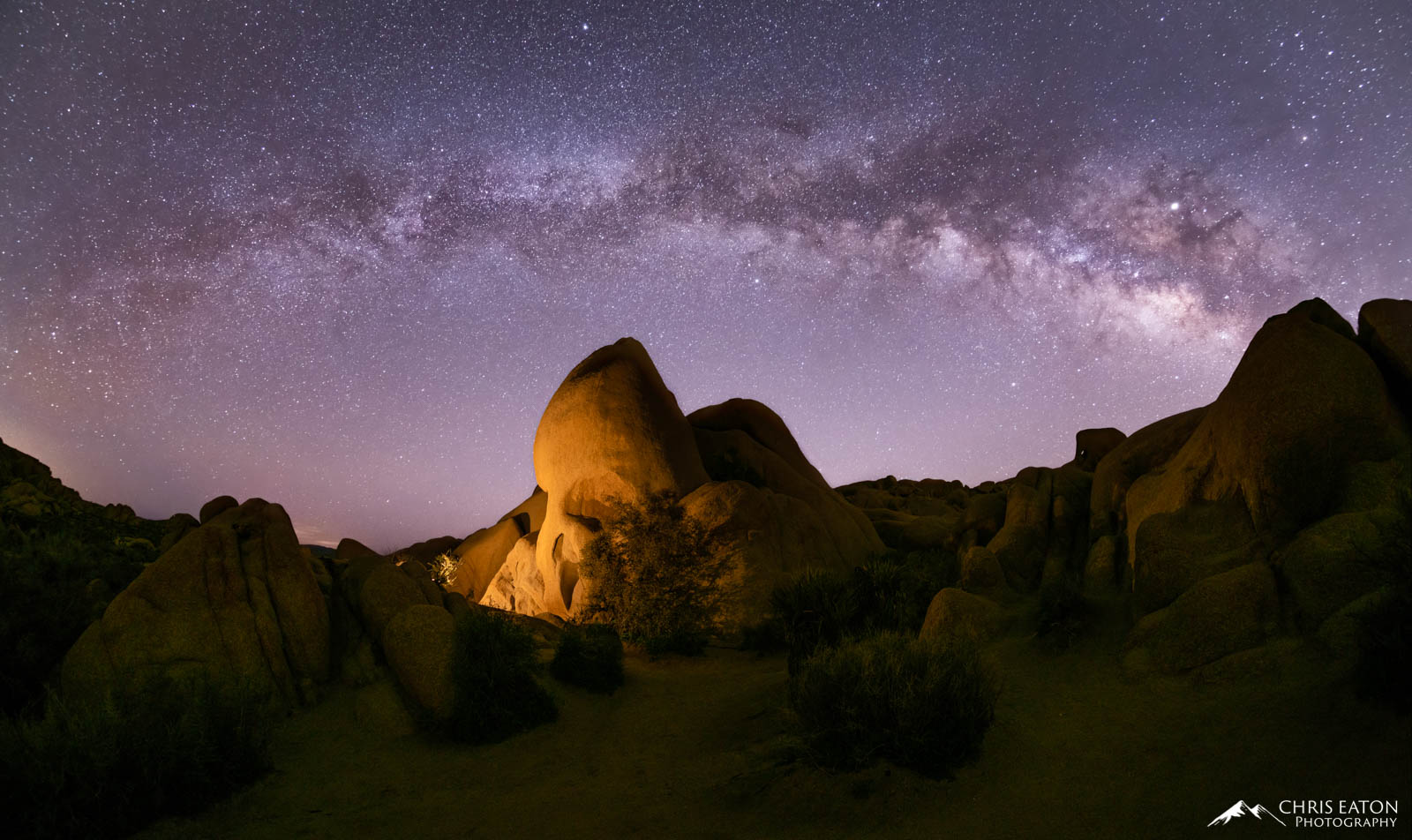 The early spring Milky Way arches over Skull Rock in the Jumbo Rocks area of Joshua Tree National Park.