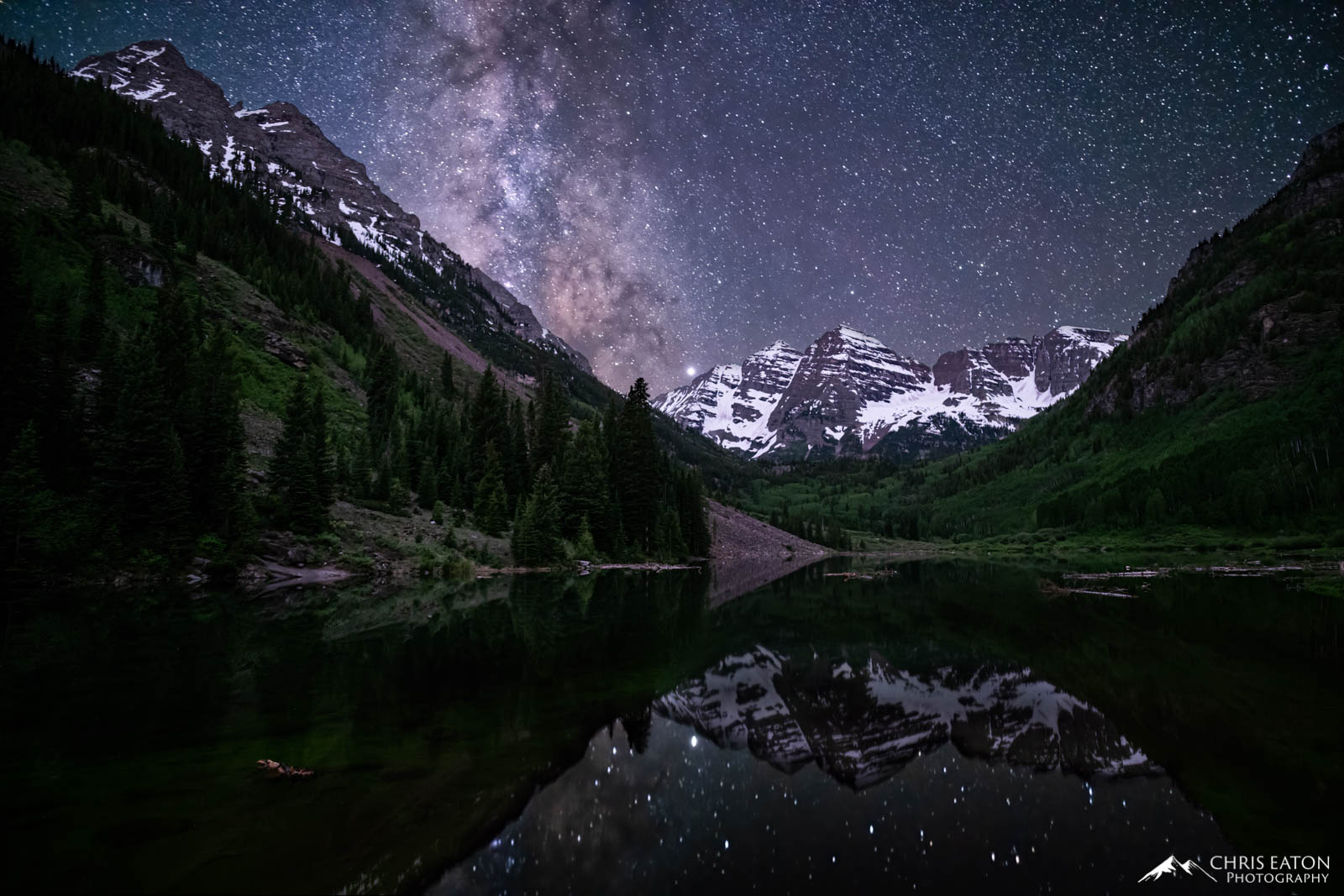The Milky Way, our galaxy, rises over the Maroon Bells and Maroon Lake, where its reflection imprints the calm waters.