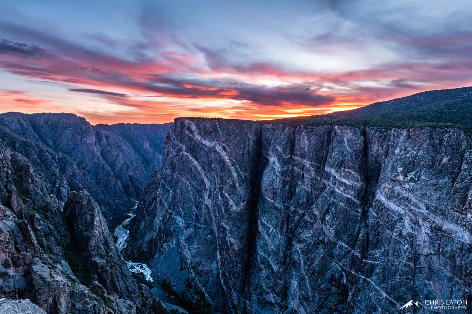 An Evening Sunset Over the Painted Wall The receeding sunset paints the high clouds above the Painted Wall in Black Canyon oif the Gunnison National Park. The Painted...